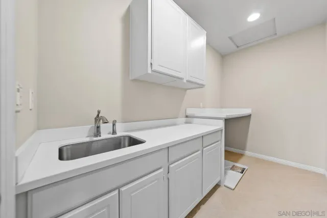 a kitchen with a sink and cabinets
