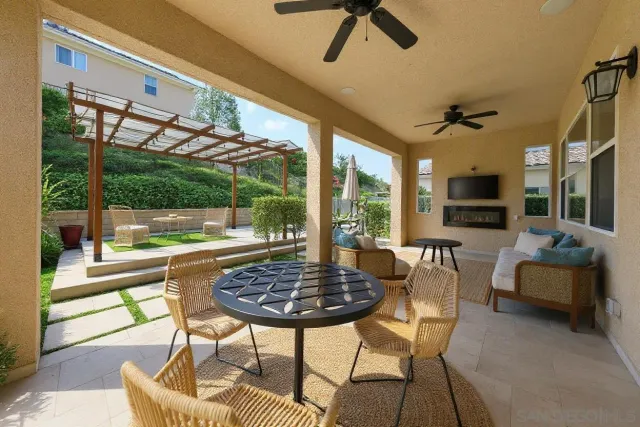 a outdoor living space with furniture and a flat screen tv