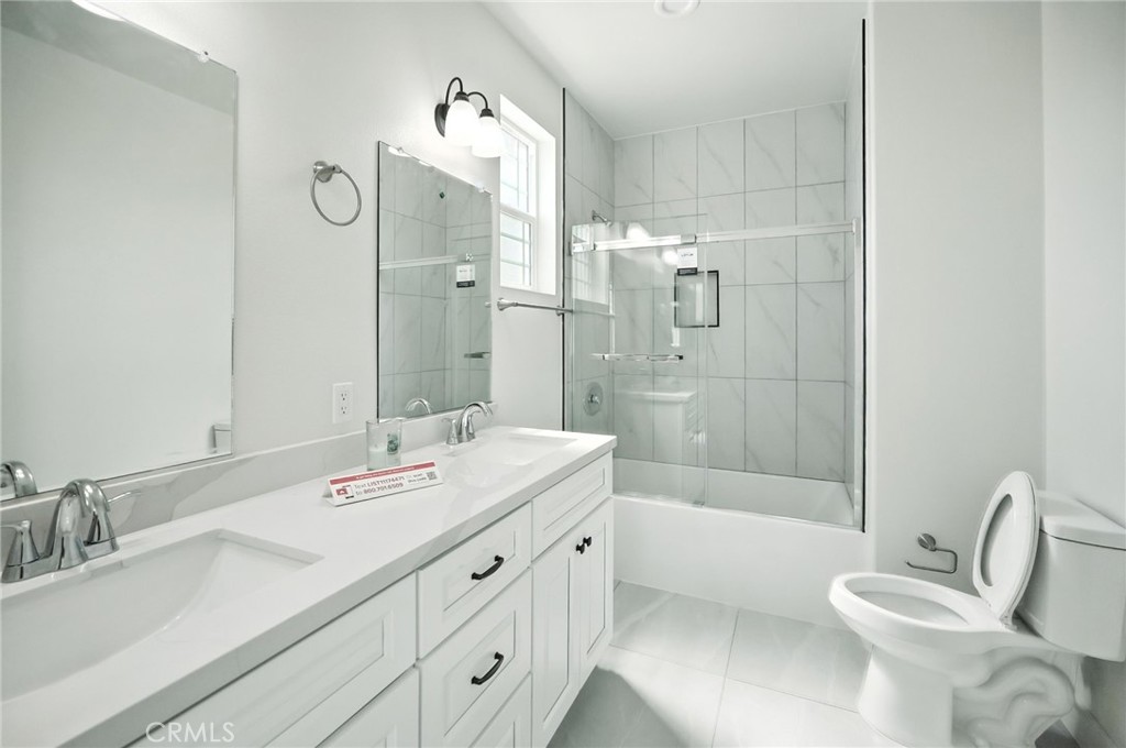 5151 Peony Court Riverside, CA 92506 - Photo 14 of 23 a bathroom with a sink double vanity granite tub and shower