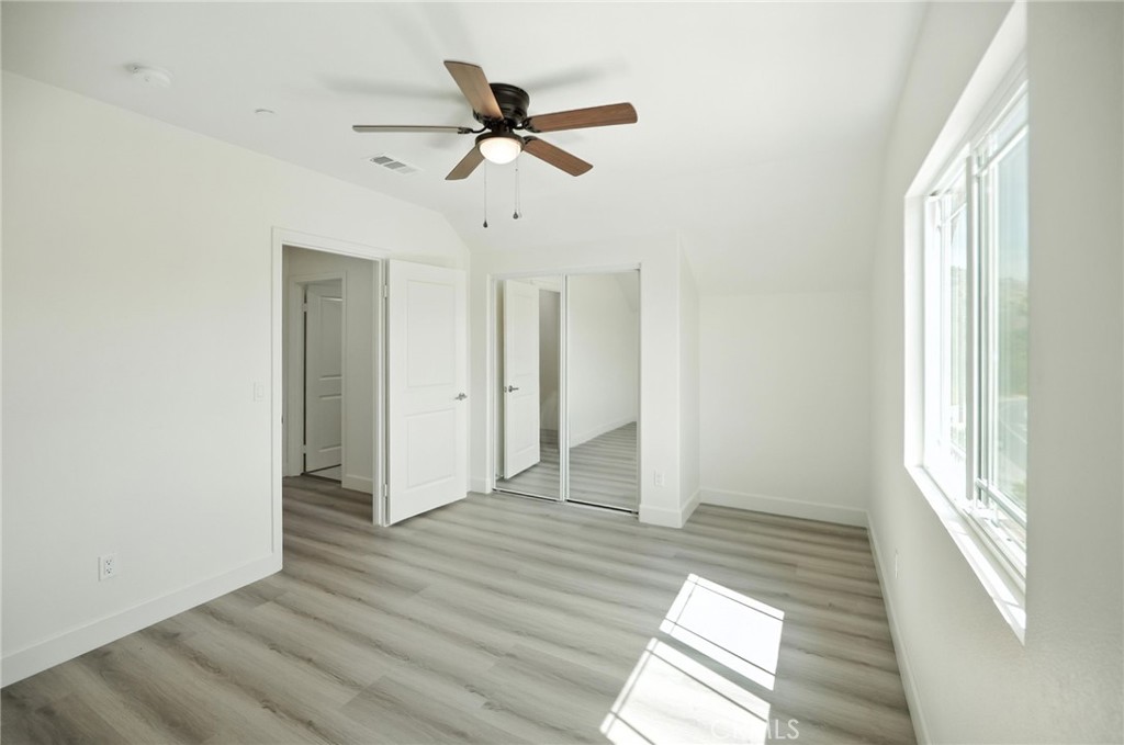 5151 Peony Court Riverside, CA 92506 - Photo 16 of 23 a view of empty room with wooden floor and fan