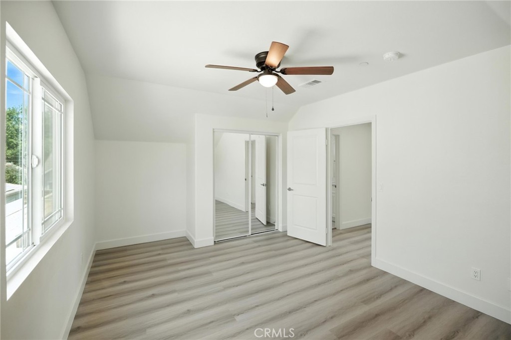 5151 Peony Court Riverside, CA 92506 - Photo 18 of 23 a view of empty room with wooden floor and window