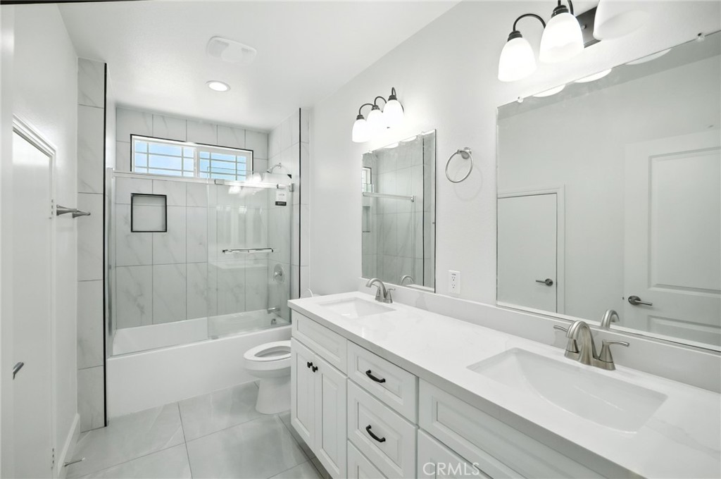 5151 Peony Court Riverside, CA 92506 - Photo 20 of 23 a bathroom with a double vanity sink toilet mirror and shower