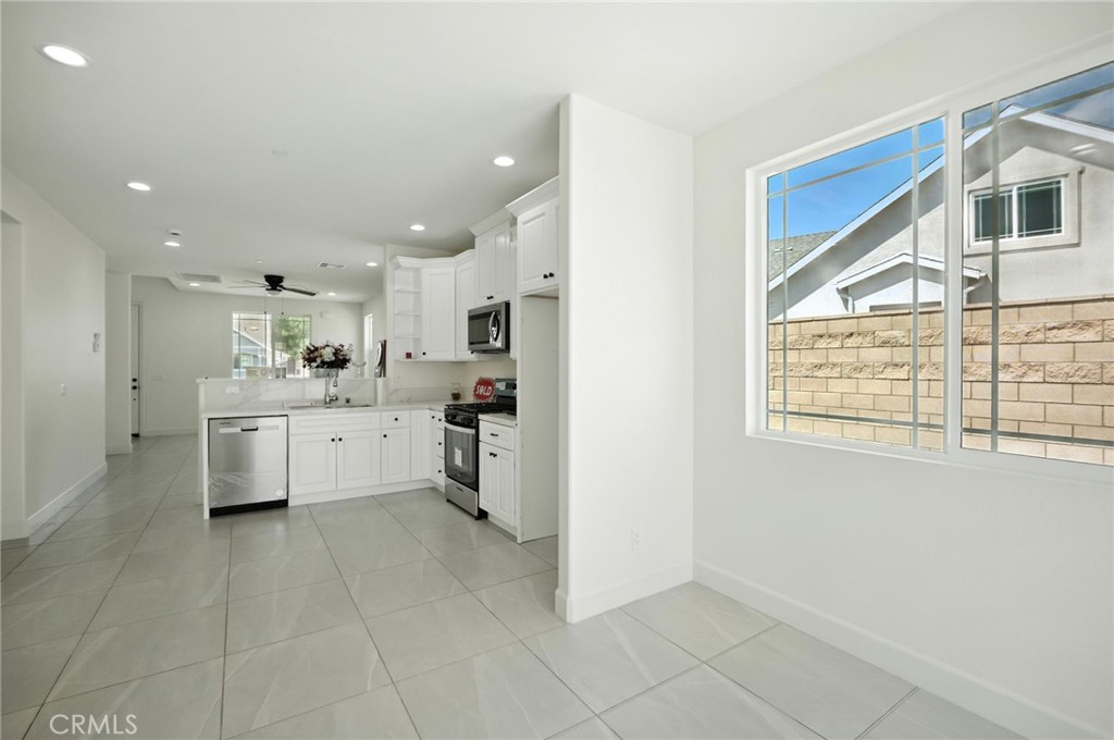 5151 Peony Court Riverside, CA 92506 - Photo 8 of 23 a kitchen with stainless steel appliances cabinets a sink and a window