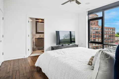 a bedroom with a bed and a flat screen tv