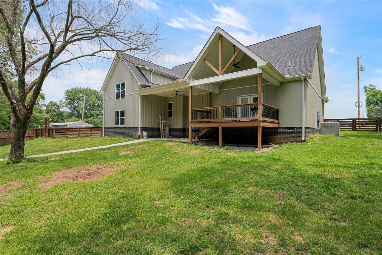 6400 Williams Road Cross Plains, TN 37049 - Photo 10 of 11 a view of a house with a flat tv screen and a backyard