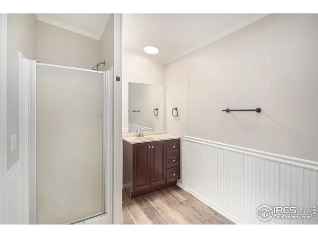 a bathroom with a sink a mirror and a shower