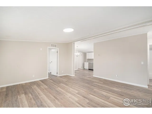 a view of an empty room and wooden floor