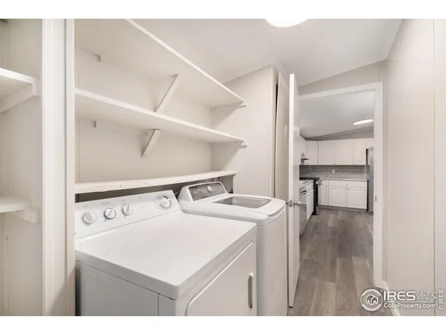 a kitchen with a sink a stove and two painting