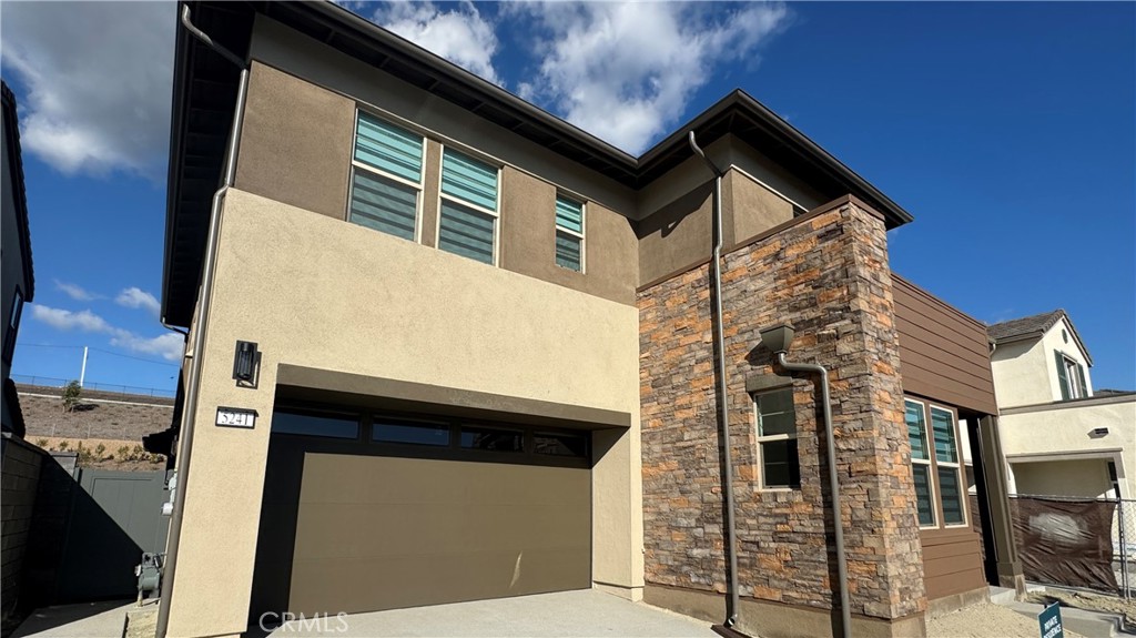 5241 Solace Drive Rancho Mission Viejo, CA 92694 - Photo 1 of 1 a front view of a house with parking