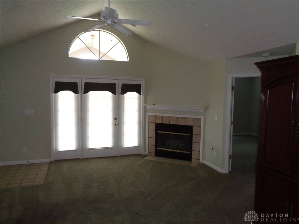 80 Villa Pointe Drive Springboro, OH 45066 - Photo 5 of 19 This inviting room features a vaulted ceiling, elegant French doors, and a cozy fireplace.