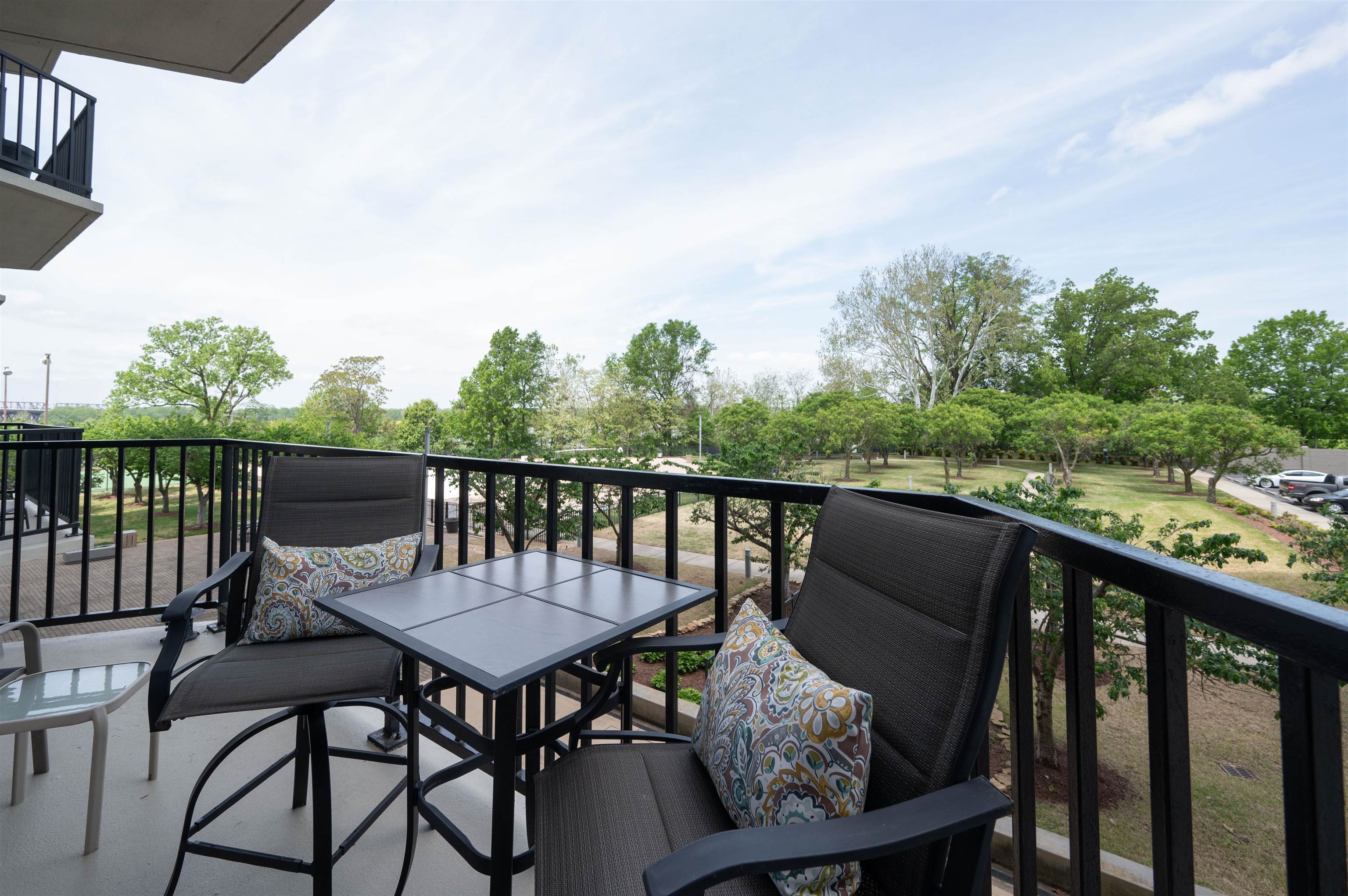 655 Riverside Drive, Unit 203 Memphis, TN 38103 - Photo 16 of 26 a view of a chairs and table on the deck