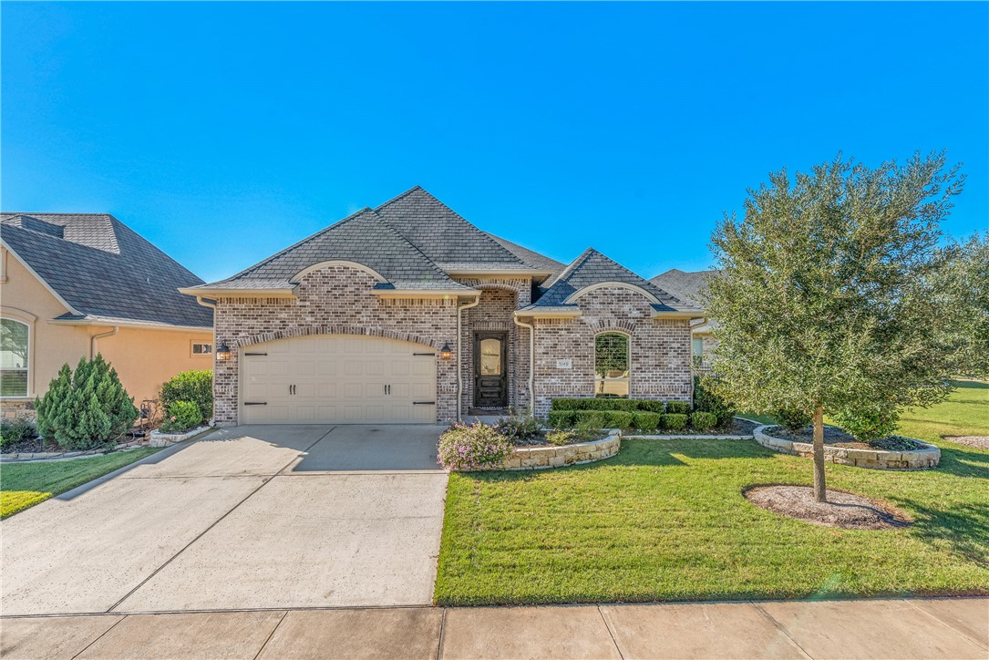 5149 Stonewater Loop College Station, TX 77845 - Photo 1 of 37 a front view of a house with a yard