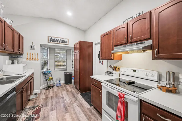 a kitchen with a stove and a refrigerator