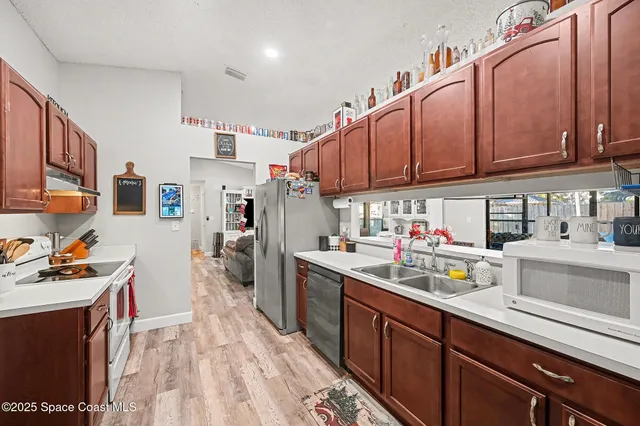 a kitchen with stainless steel appliances granite countertop a sink stove and cabinets