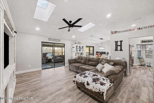 a living room with furniture and wooden floor