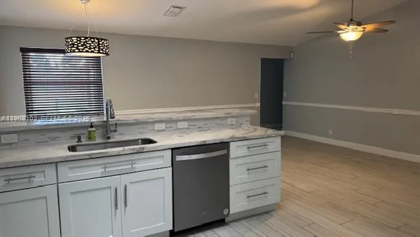 a kitchen with a sink cabinets and window