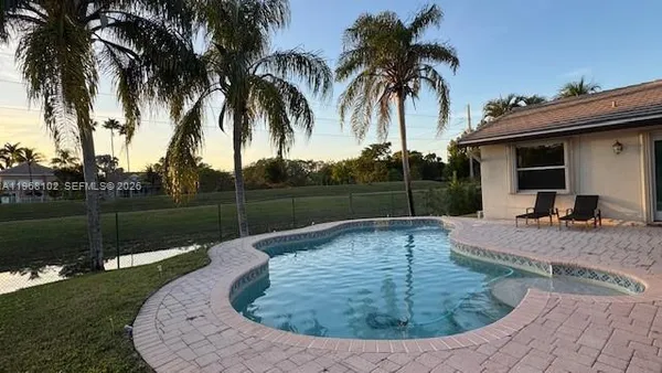 a view of a backyard with swimming pool