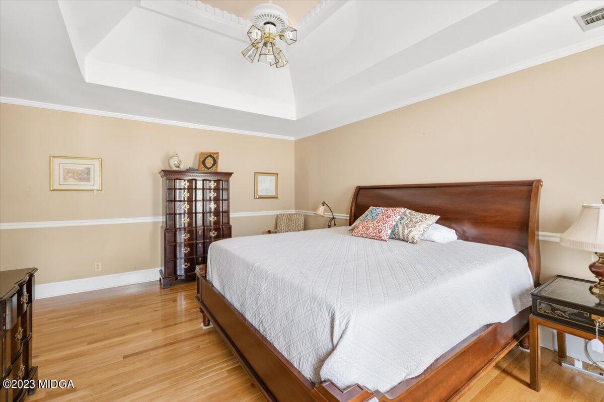 191 Rivoli Landing Macon, GA 31210 - Photo 18 of 45 a bedroom with a bed and wooden floor