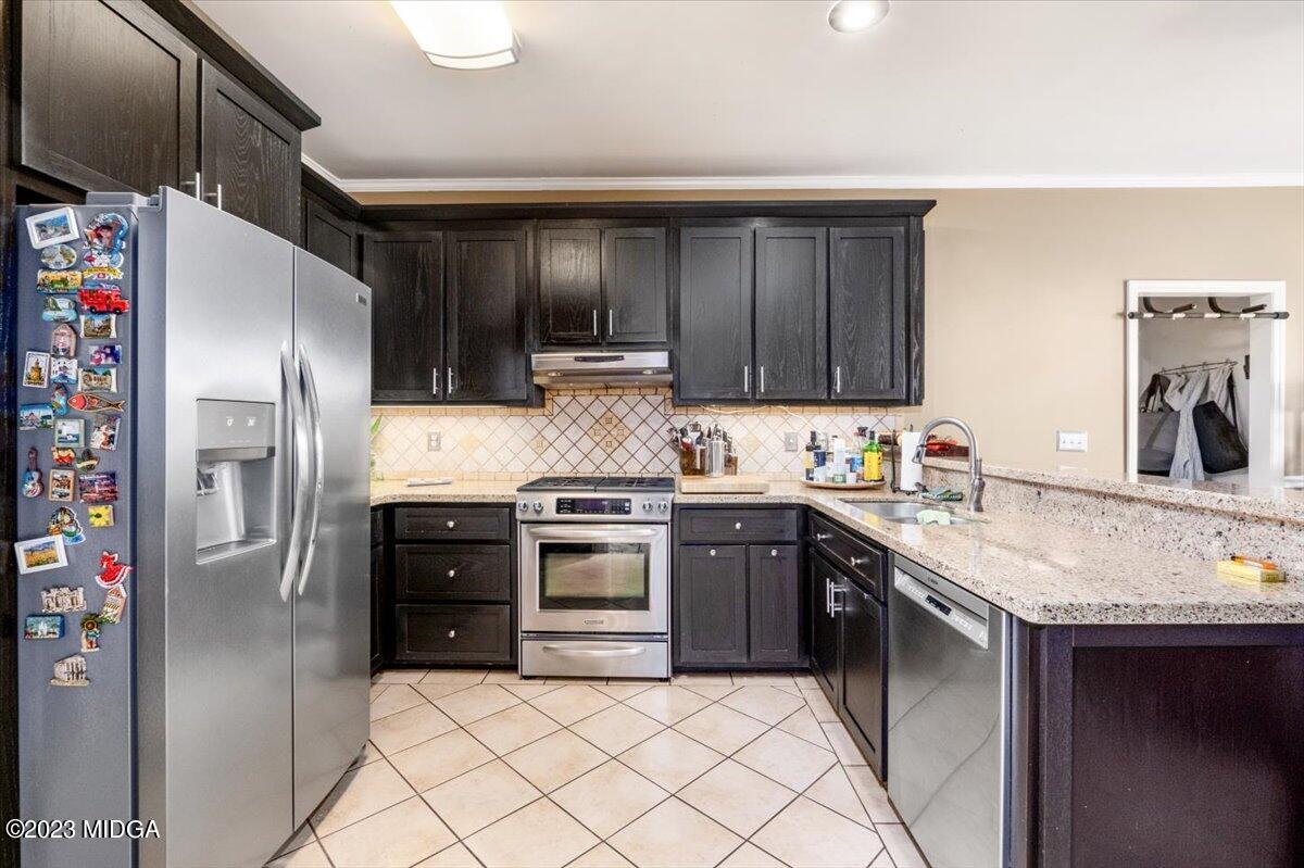191 Rivoli Landing Macon, GA 31210 - Photo 9 of 45 a kitchen with granite countertop a sink stainless steel appliances and cabinets