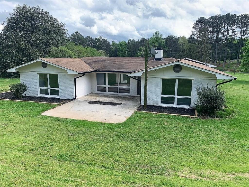 2435 Miller Ferry Road Southwest Calhoun, GA 30701 - Photo 3 of 21 a front view of a house with a yard and trees