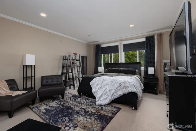 a bedroom with a bed a couch and dresser