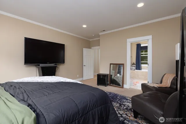 a bedroom with a bed and a flat screen television