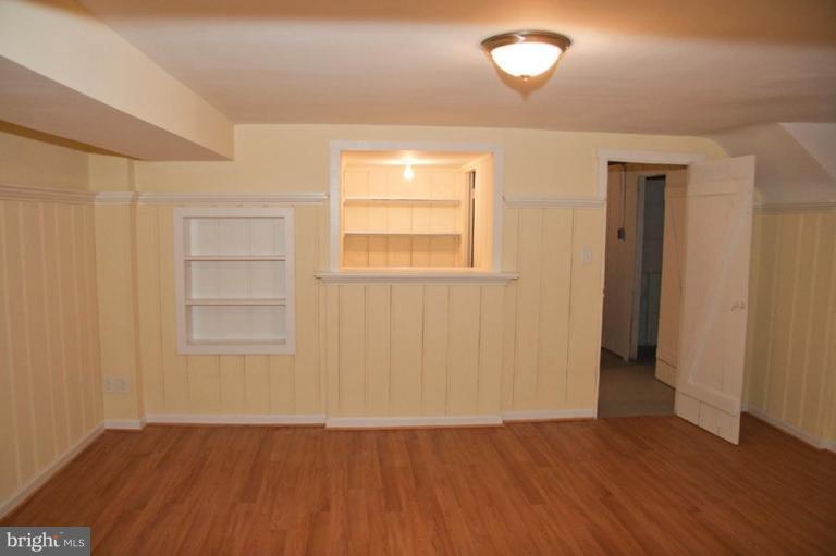 1538 Northgate Road Baltimore, MD 21218 - Photo 13 of 30 an empty room with wooden floor and windows