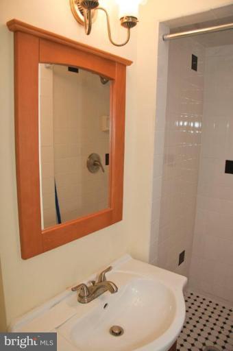 1538 Northgate Road Baltimore, MD 21218 - Photo 16 of 30 a bathroom with a sink and a mirror