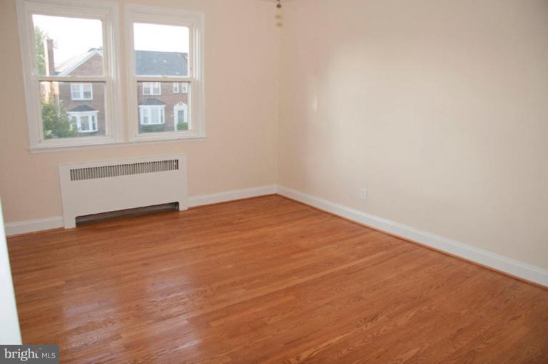1538 Northgate Road Baltimore, MD 21218 - Photo 18 of 30 an empty room with wooden floor and windows