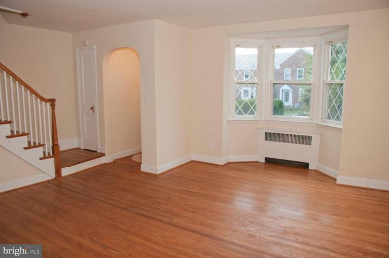1538 Northgate Road Baltimore, MD 21218 - Photo 3 of 30 an empty room with wooden floor and windows