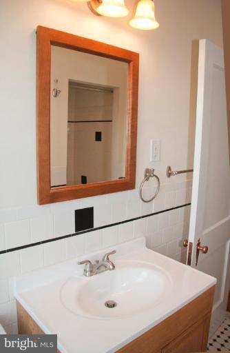 1538 Northgate Road Baltimore, MD 21218 - Photo 22 of 30 a bathroom with a sink and a mirror