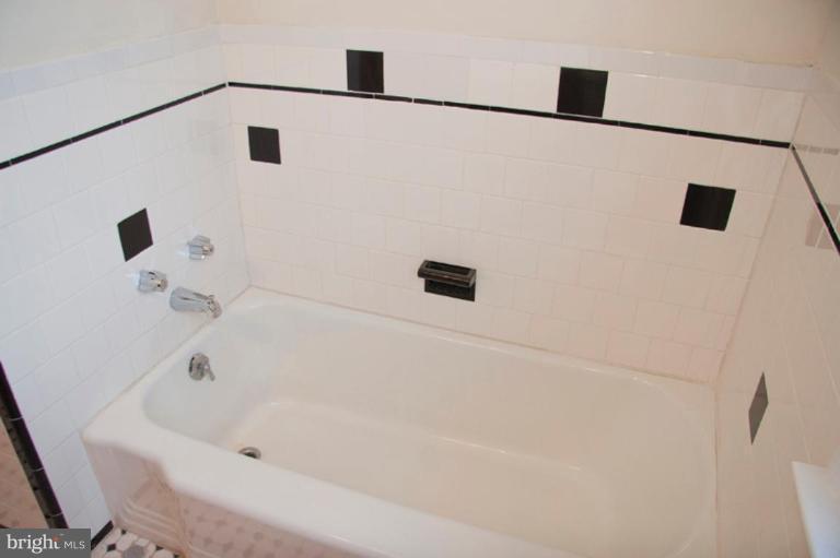 1538 Northgate Road Baltimore, MD 21218 - Photo 23 of 30 a white bath tub sitting next to a shower