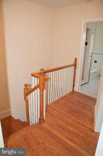 1538 Northgate Road Baltimore, MD 21218 - Photo 25 of 30 a view of a bedroom with wooden floor and a rug