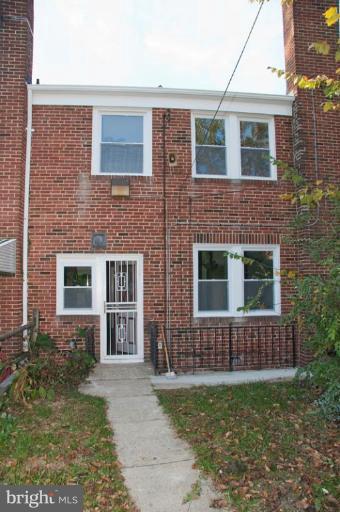 1538 Northgate Road Baltimore, MD 21218 - Photo 26 of 30 front view of a brick house with a small yard
