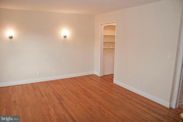 1538 Northgate Road Baltimore, MD 21218 - Photo 5 of 30 an empty room with wooden floor and windows in it