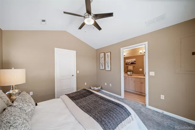 a bedroom with a bed and a lamp