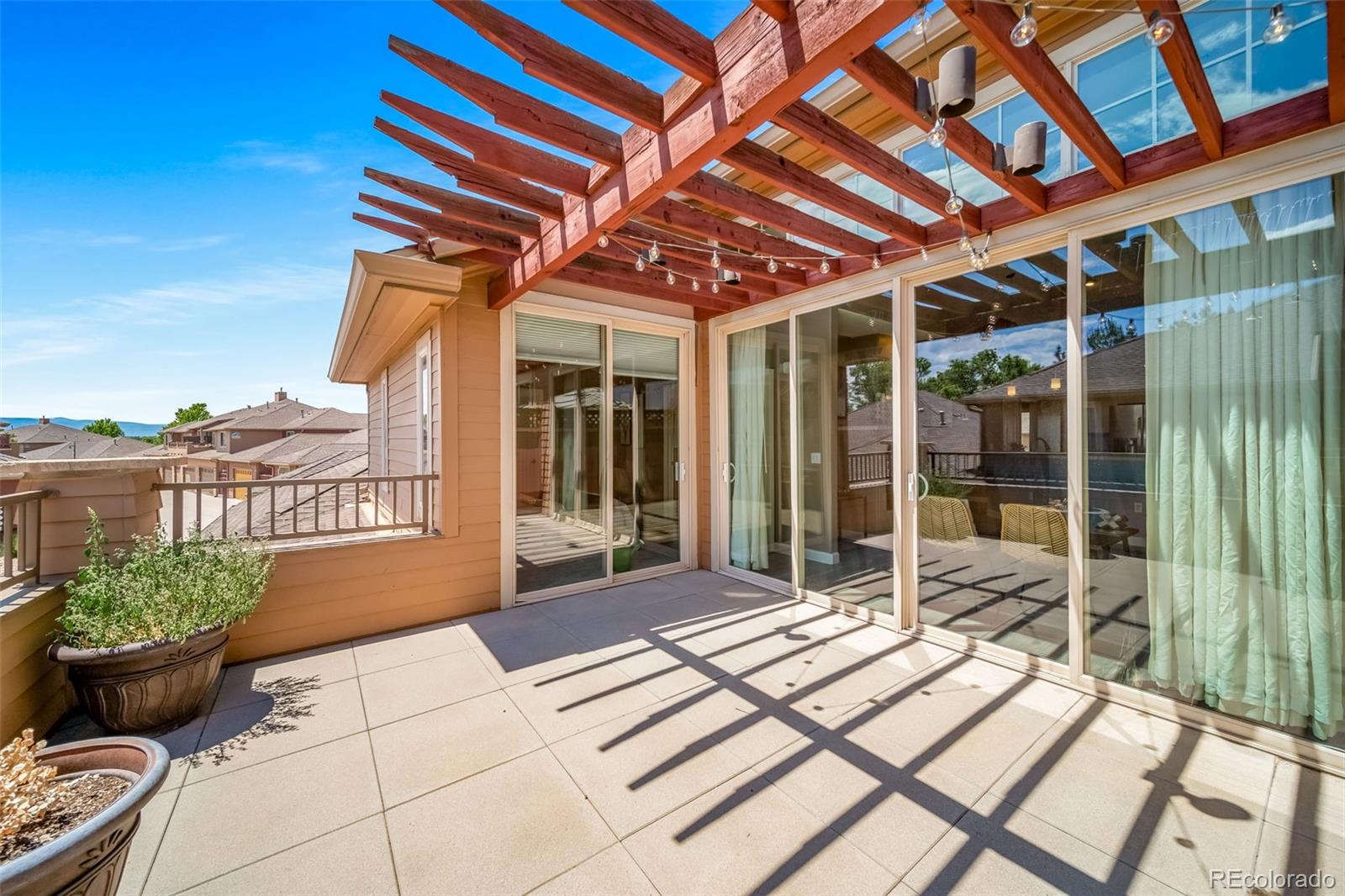 8626 Gold Peak Drive, Unit B Highlands Ranch, CO 80130 - Photo 17 of 40 a view of balcony with wooden floor and outdoor seating