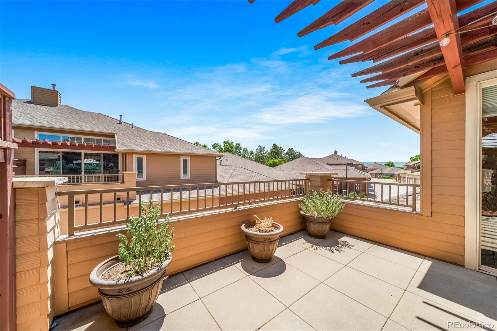 8626 Gold Peak Drive, Unit B Highlands Ranch, CO 80130 - Photo 18 of 40 a view of a patio with couches chairs and potted plants