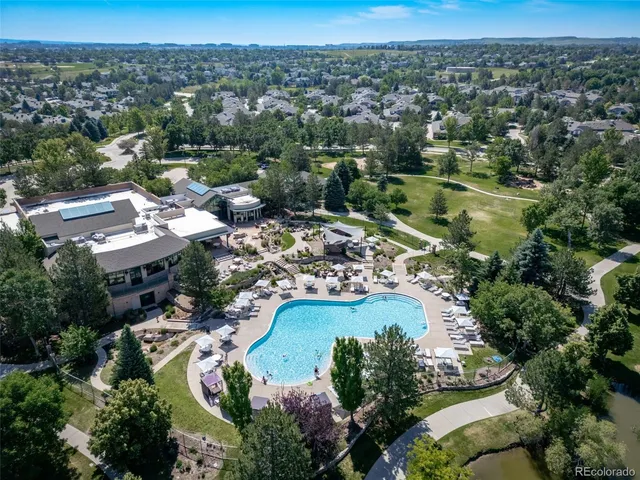 an aerial view of residential houses with outdoor space and river