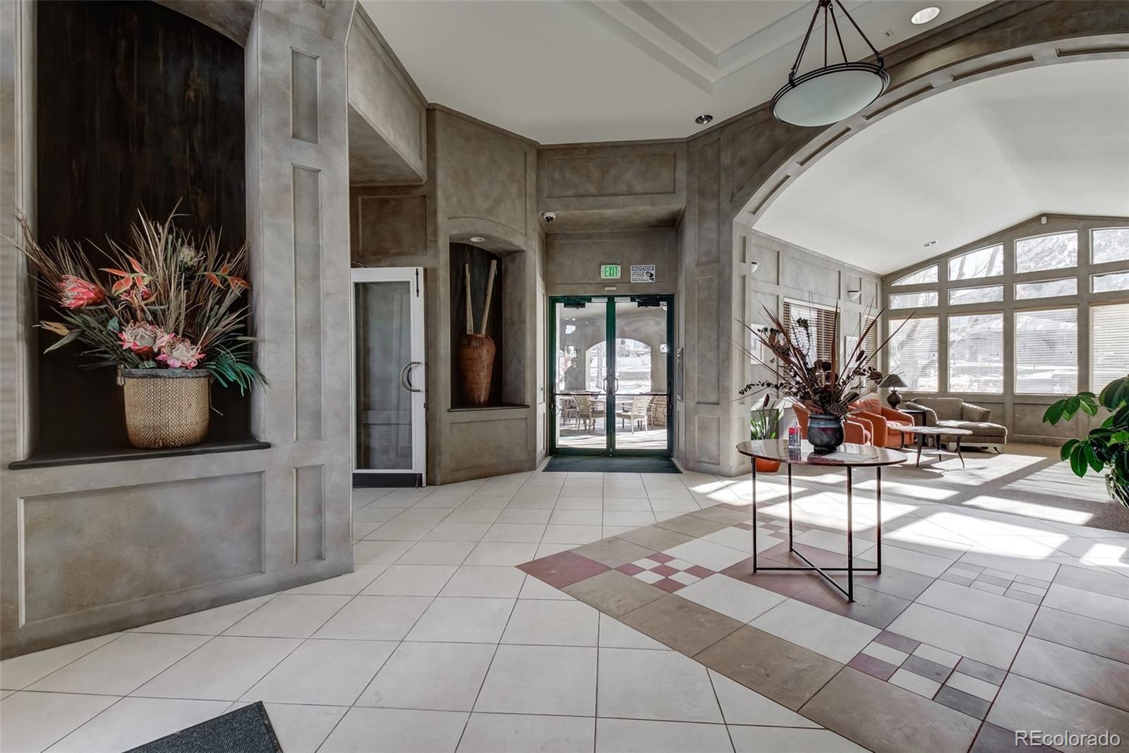 8626 Gold Peak Drive, Unit B Highlands Ranch, CO 80130 - Photo 27 of 40 a view of a entryway with furniture and floor to ceiling window