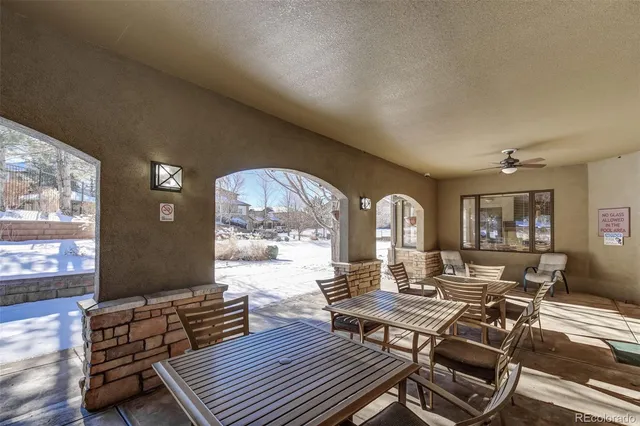 a living room with furniture a large window and a table