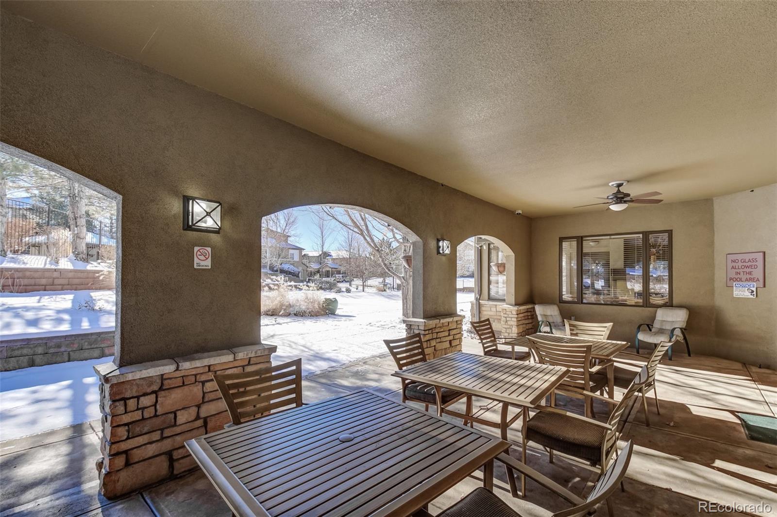 8626 Gold Peak Drive, Unit B Highlands Ranch, CO 80130 - Photo 30 of 40 a living room with furniture a large window and a table