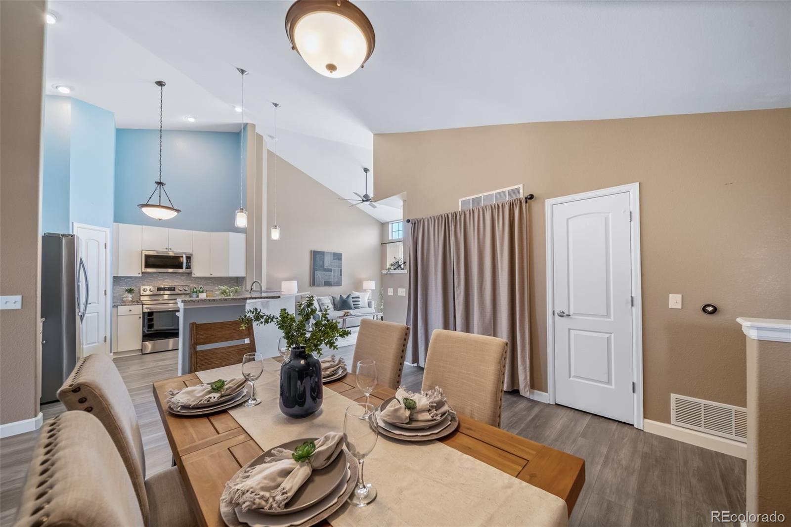 8626 Gold Peak Drive, Unit B Highlands Ranch, CO 80130 - Photo 3 of 40 a kitchen with stainless steel appliances granite countertop a refrigerator and a wooden floor