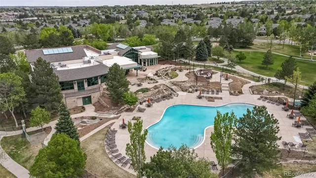 an aerial view of a house with a garden and lake view