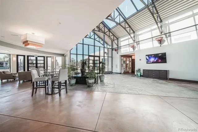 a dining room with furniture and a floor to ceiling window