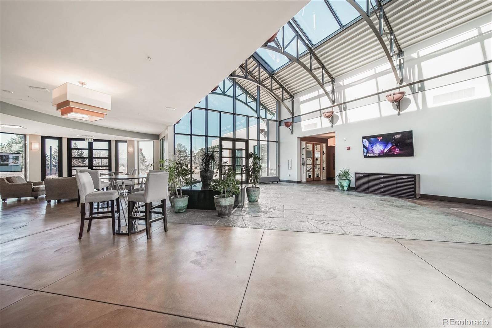 8626 Gold Peak Drive, Unit B Highlands Ranch, CO 80130 - Photo 37 of 40 a dining room with furniture and a floor to ceiling window