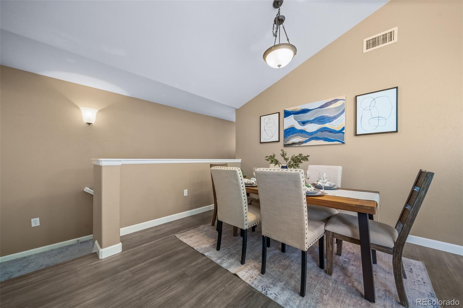 8626 Gold Peak Drive, Unit B Highlands Ranch, CO 80130 - Photo 4 of 40 a view of a dining room with furniture and wooden floor