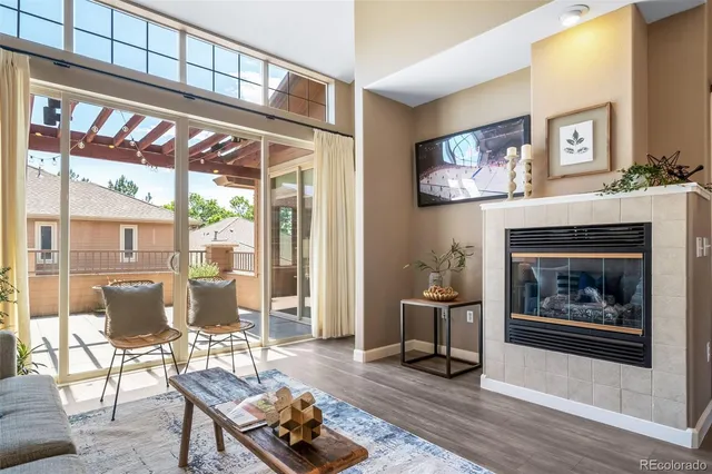 a living room with furniture a table and a fireplace
