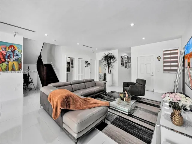 a bedroom with furniture and flat screen tv