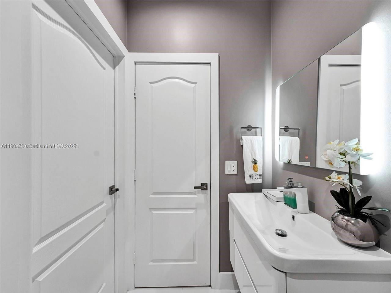 7565 Northwest 177th Terrace, Unit 7565 Hialeah, FL 33015 - Photo 11 of 35 a bathroom with a bathtub and a sink